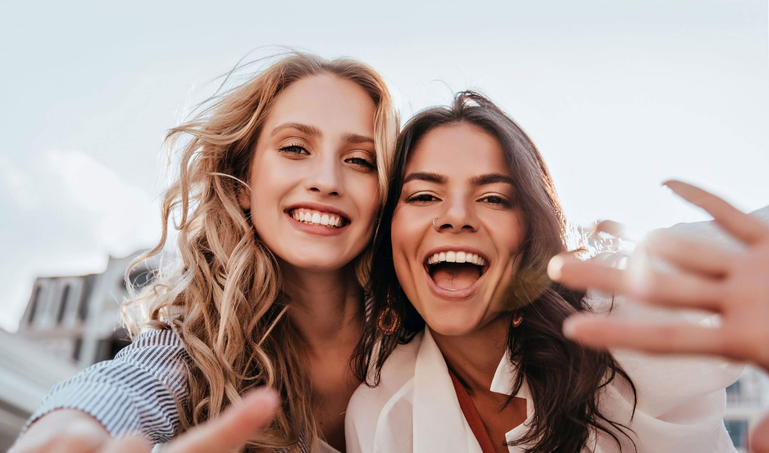 Two girls looking into the camera and showing off their smile | Loughborough Ortho